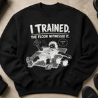 Sweatshirt with black background and white graphic of person collapsed on floor with text