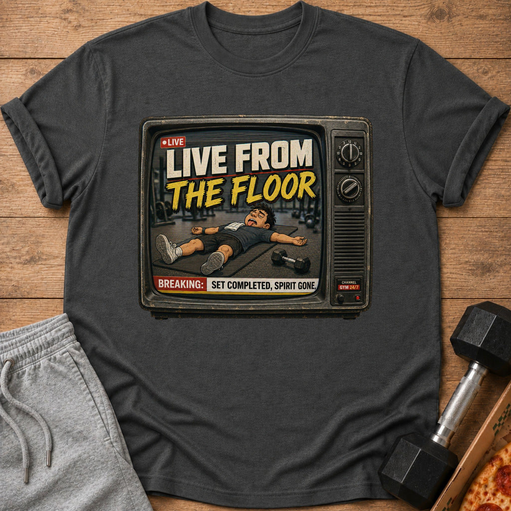 Graphic t-shirt with "LIVE FROM THE FLOOR" text and cartoon of exhausted person on gym floor.