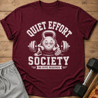 Maroon t-shirt with cartoon kettlebell graphic and text "QUIET EFFORT SOCIETY NO HYPE REQUIRED".