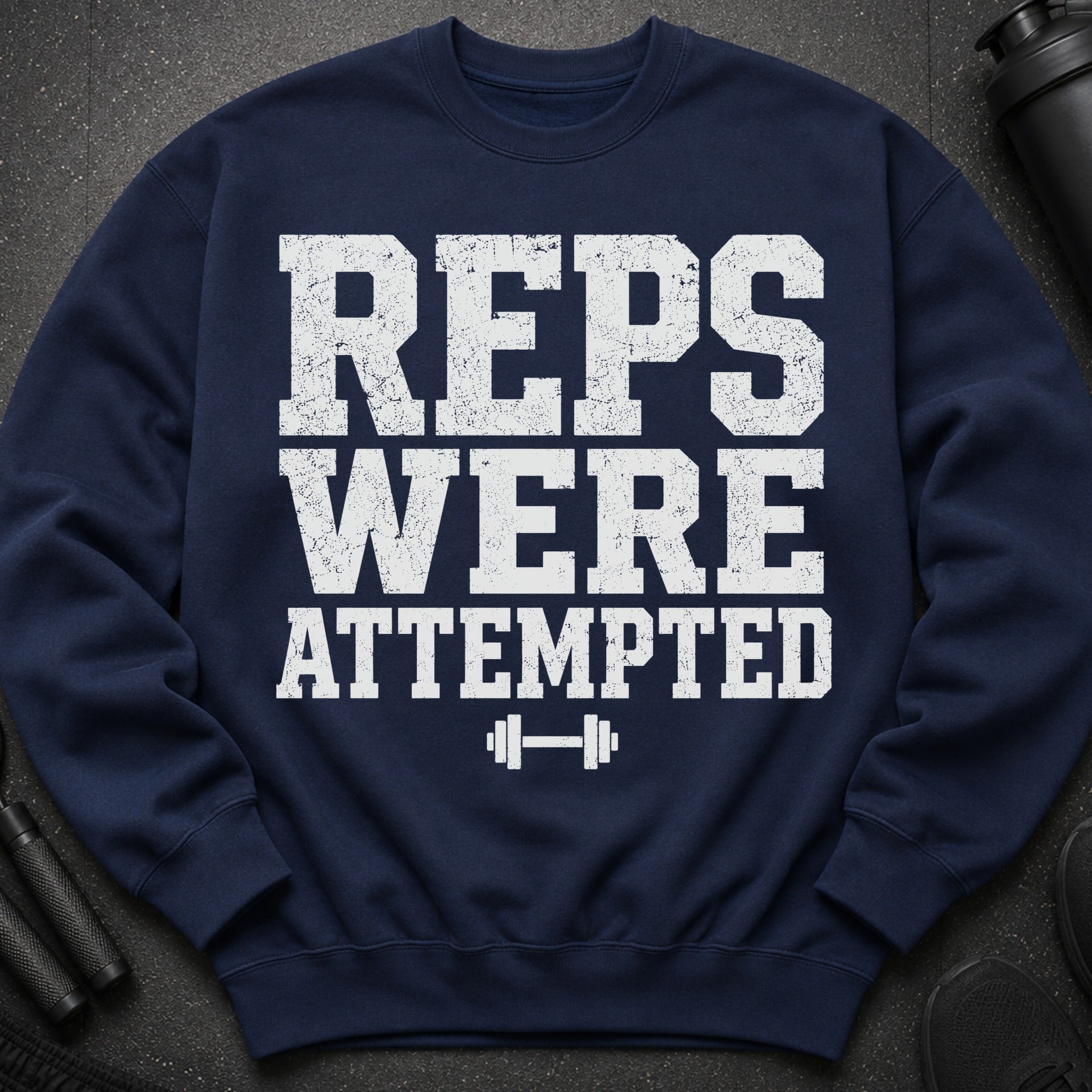 Navy sweatshirt with white distressed text "REPS WERE ATTEMPTED" and dumbbell graphic.