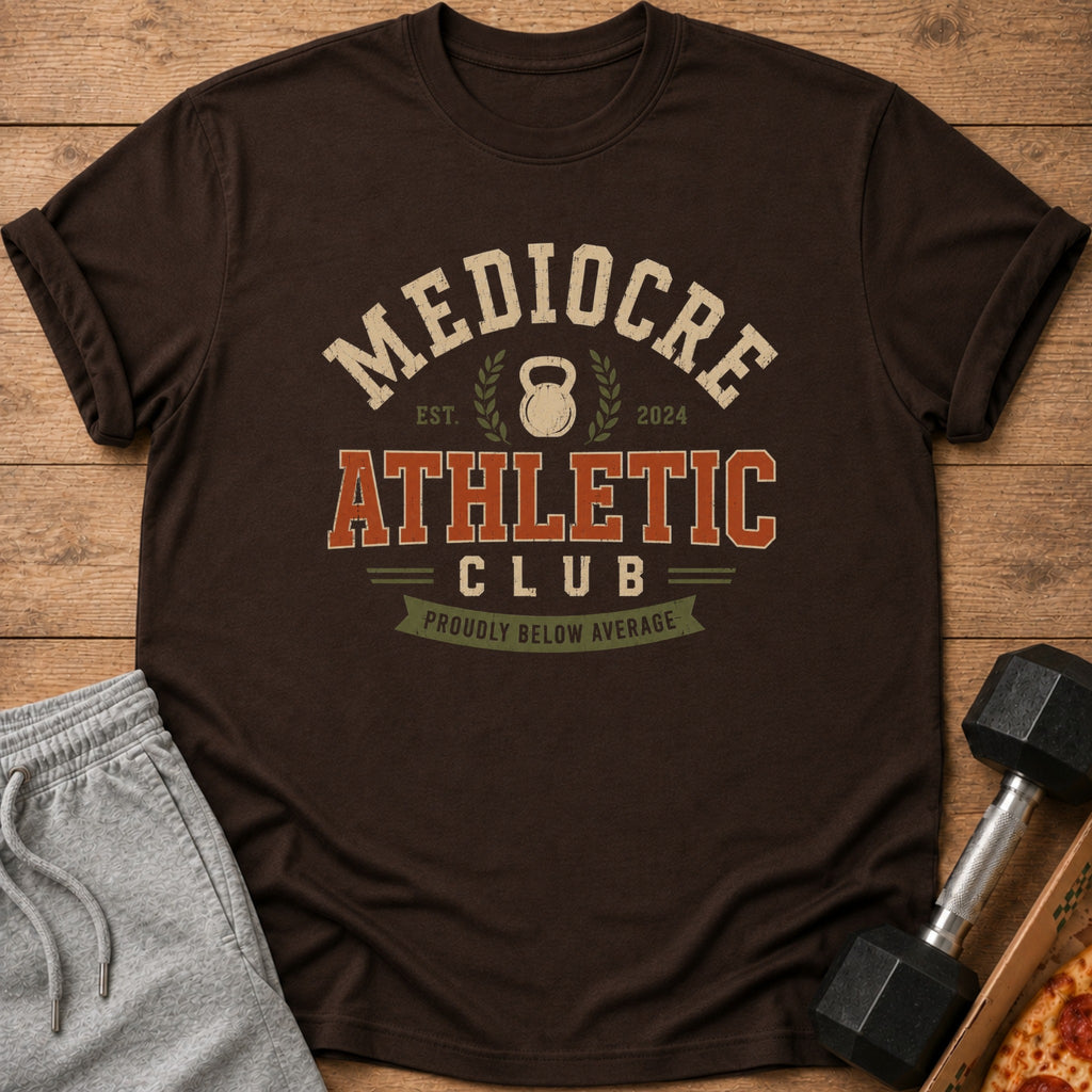 Brown t-shirt with "Mediocre Athletic Club" and kettlebell graphic.