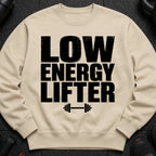 Cream sweatshirt with bold black text "LOW ENERGY LIFTER" and barbell graphic.