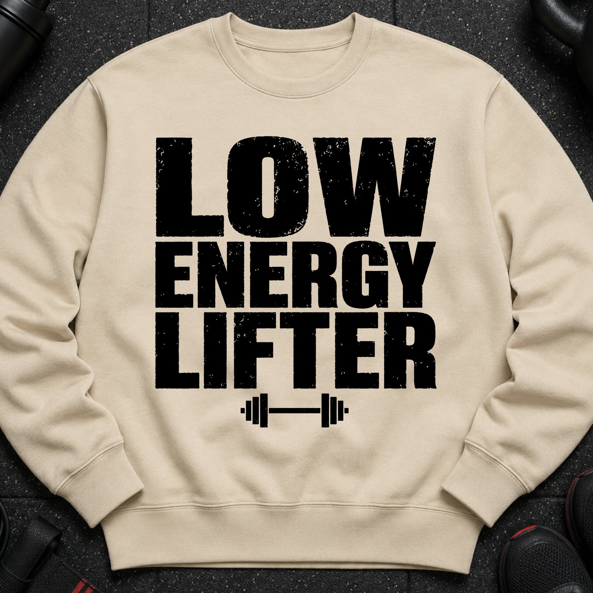 Cream sweatshirt with bold black text "LOW ENERGY LIFTER" and barbell graphic.