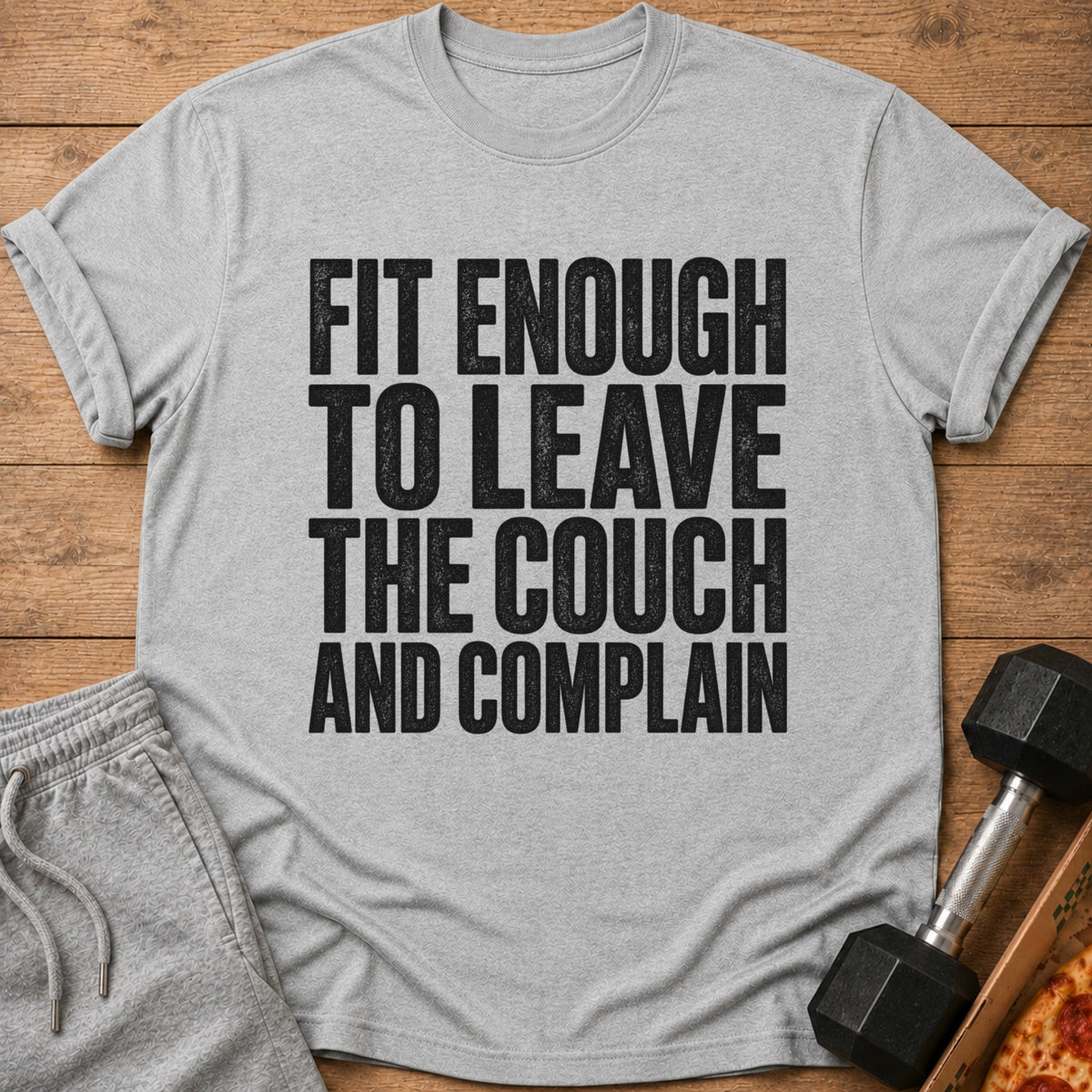 Gray t-shirt with black text reading "FIT ENOUGH TO LEAVE THE COUCH AND COMPLAIN."