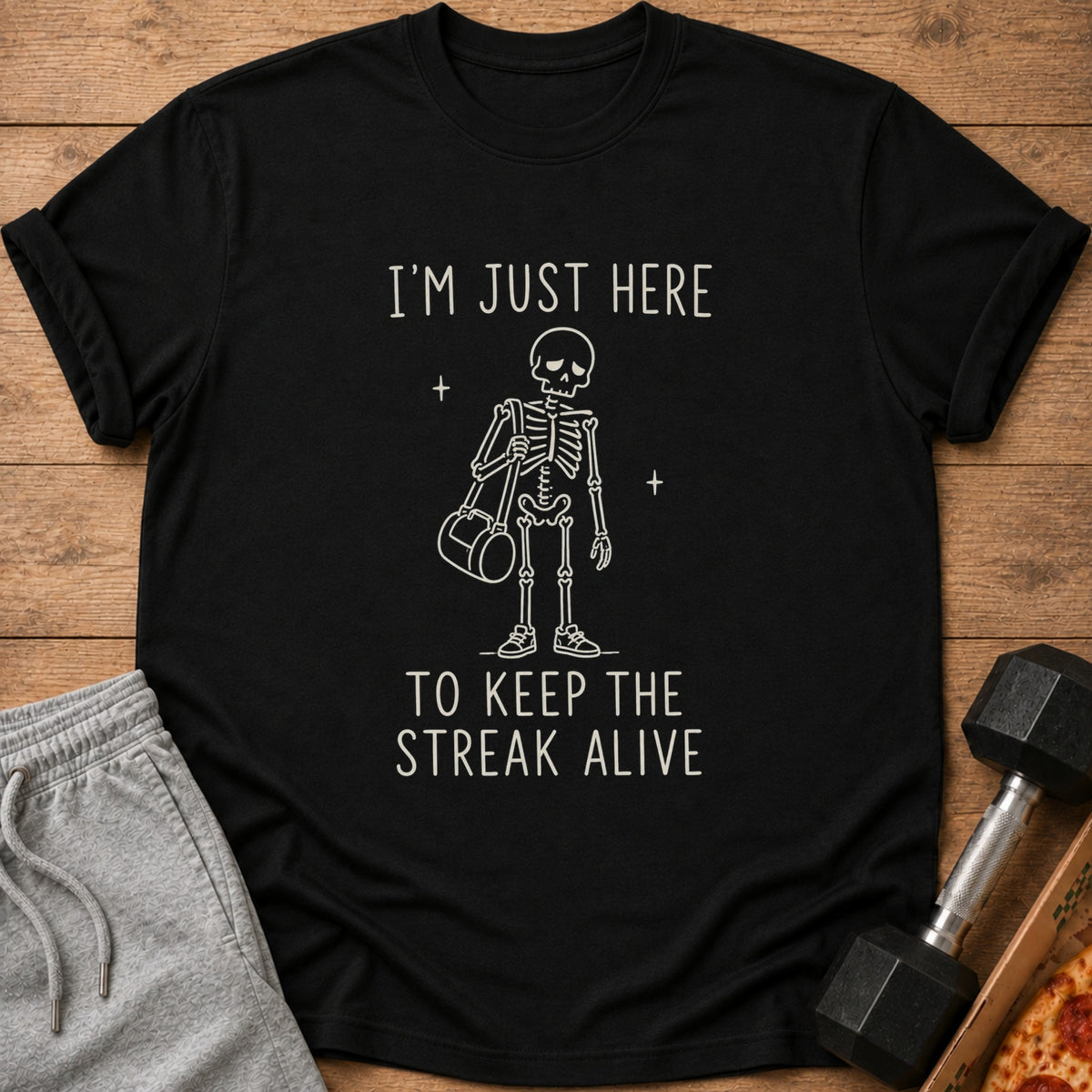 Black t-shirt with skeleton graphic and text "I'm Just Here To Keep The Streak Alive".