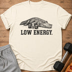 Cream t-shirt with alligator and dumbbells graphic, text reads "LOW ENERGY".