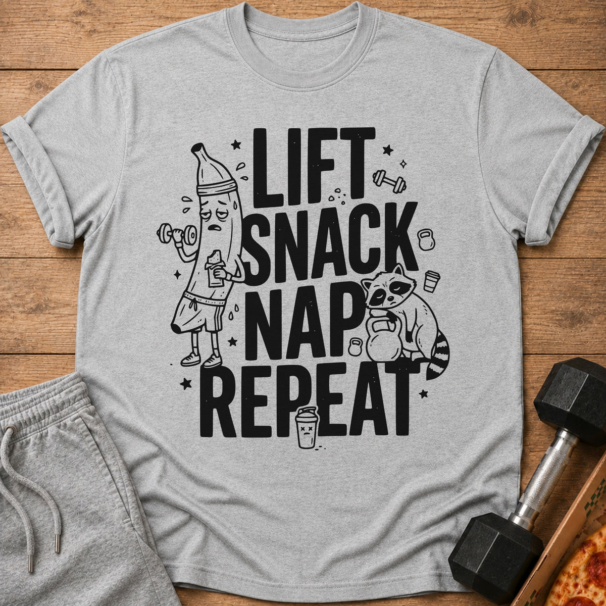 Grey t-shirt with black text and illustrations: Lift, Snack, Nap, Repeat.