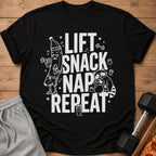 Black t-shirt with "LIFT SNACK NAP REPEAT" text and cartoon workout graphics.