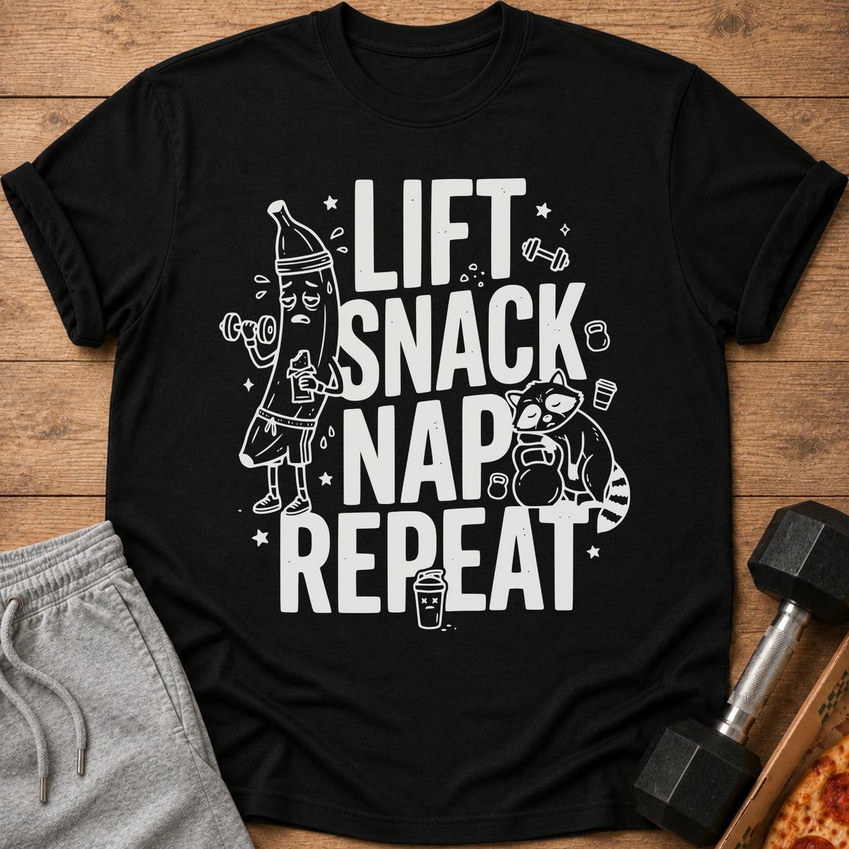 Black t-shirt with "LIFT SNACK NAP REPEAT" text and cartoon workout graphics.