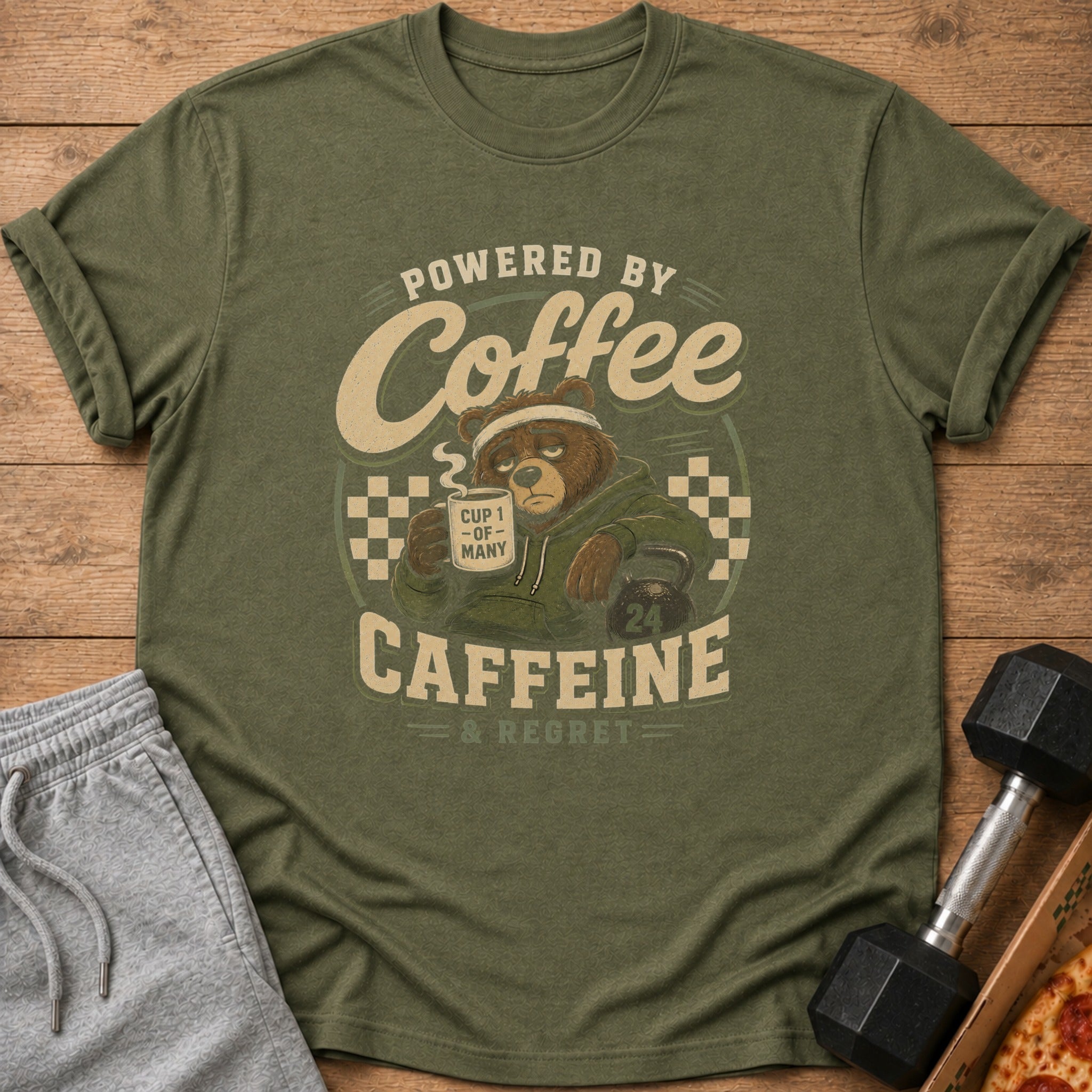 Green t-shirt with "Powered by Coffee Caffeine & Regret" text and tired bear graphic.
