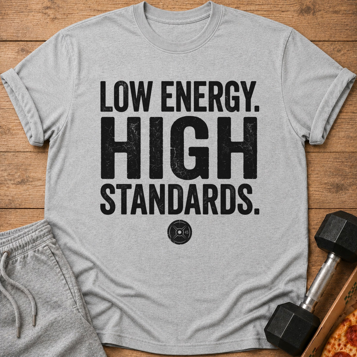 Grey t-shirt with text "LOW ENERGY. HIGH STANDARDS." and a weight plate graphic.