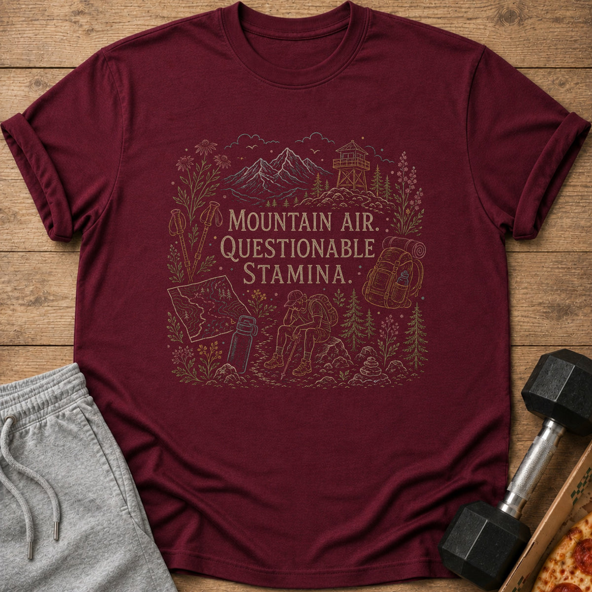Maroon t-shirt with "Mountain Air, Questionable Stamina" text and hiking illustration.