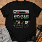 Black t-shirt with pixelated "Stamina Low. Quest Active." and gym graphics.
