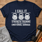 Navy t-shirt with text "I CALL IT STRENGTH TRAINING BUT MOSTLY IT'S EMOTIONAL DAMAGE" and sad kettlebells.