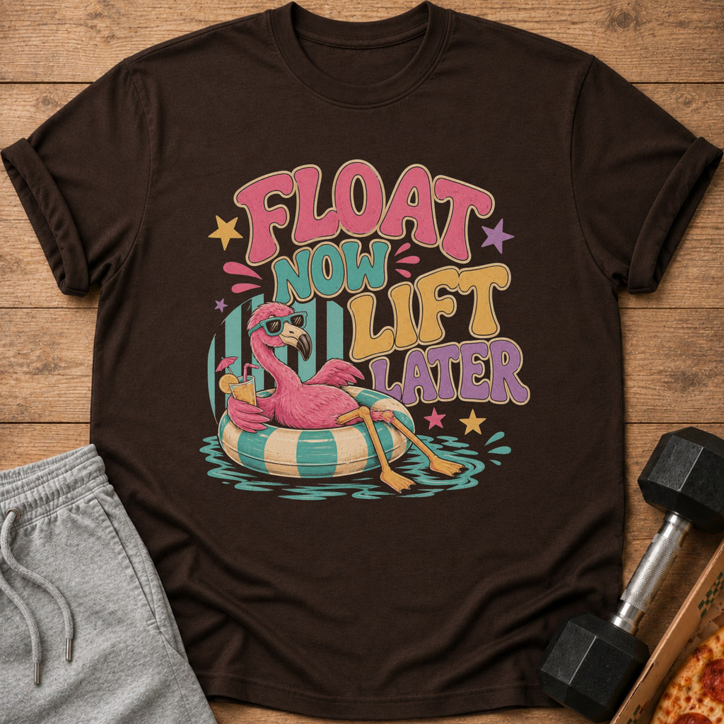 Brown t-shirt with a flamingo floating in a pool with the text "Float Now Lift Later."