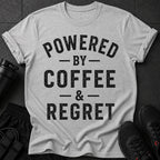 Heather gray t-shirt with black distressed text: "POWERED BY COFFEE & REGRET"