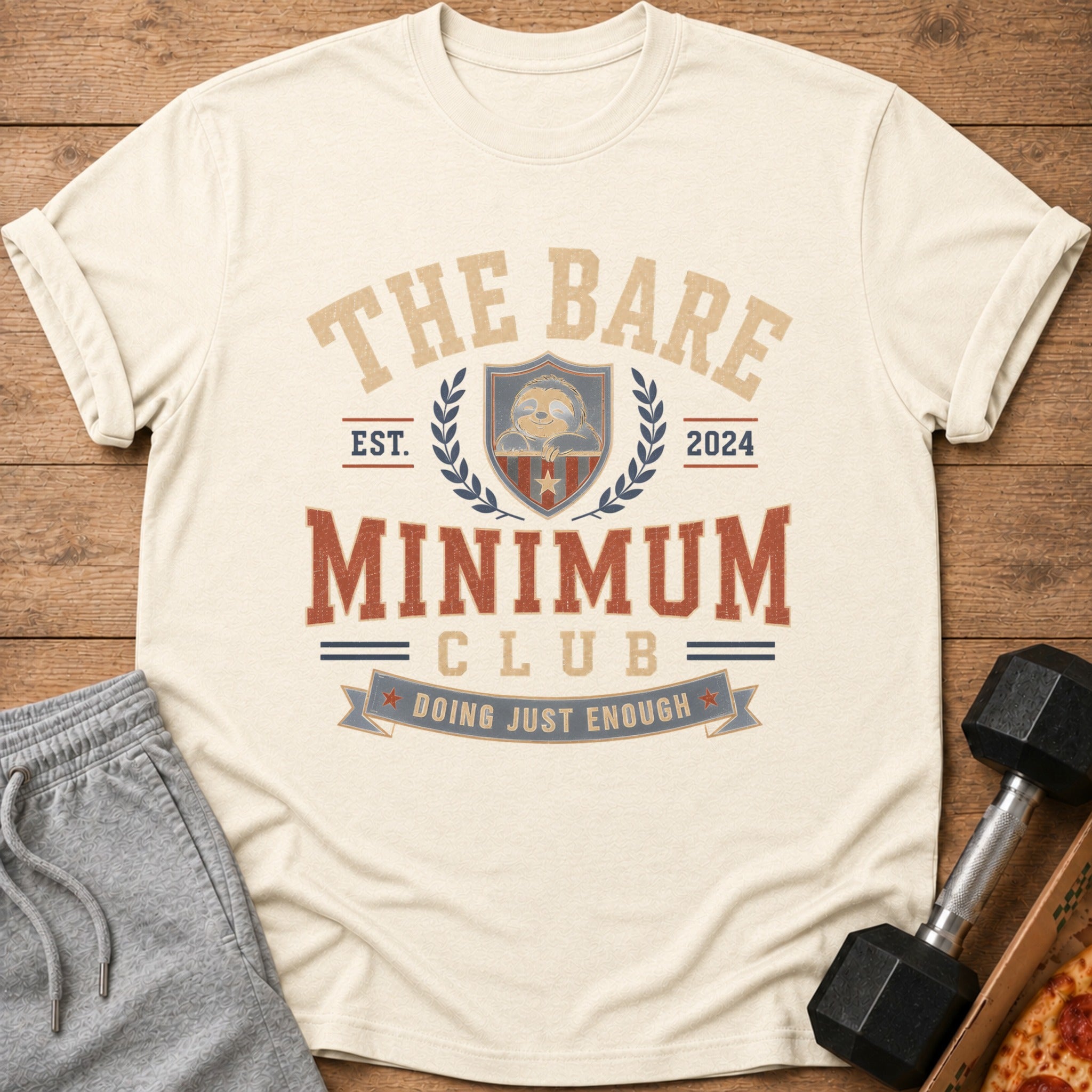 Cream t-shirt with "The Bare Minimum Club" and a sloth graphic.