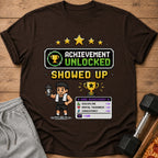 Brown t-shirt with "Achievement Unlocked Showed Up" pixel art graphic.