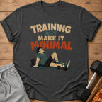 T-shirt with "Training But Make It Minimal" text and cartoon man resting with weights.