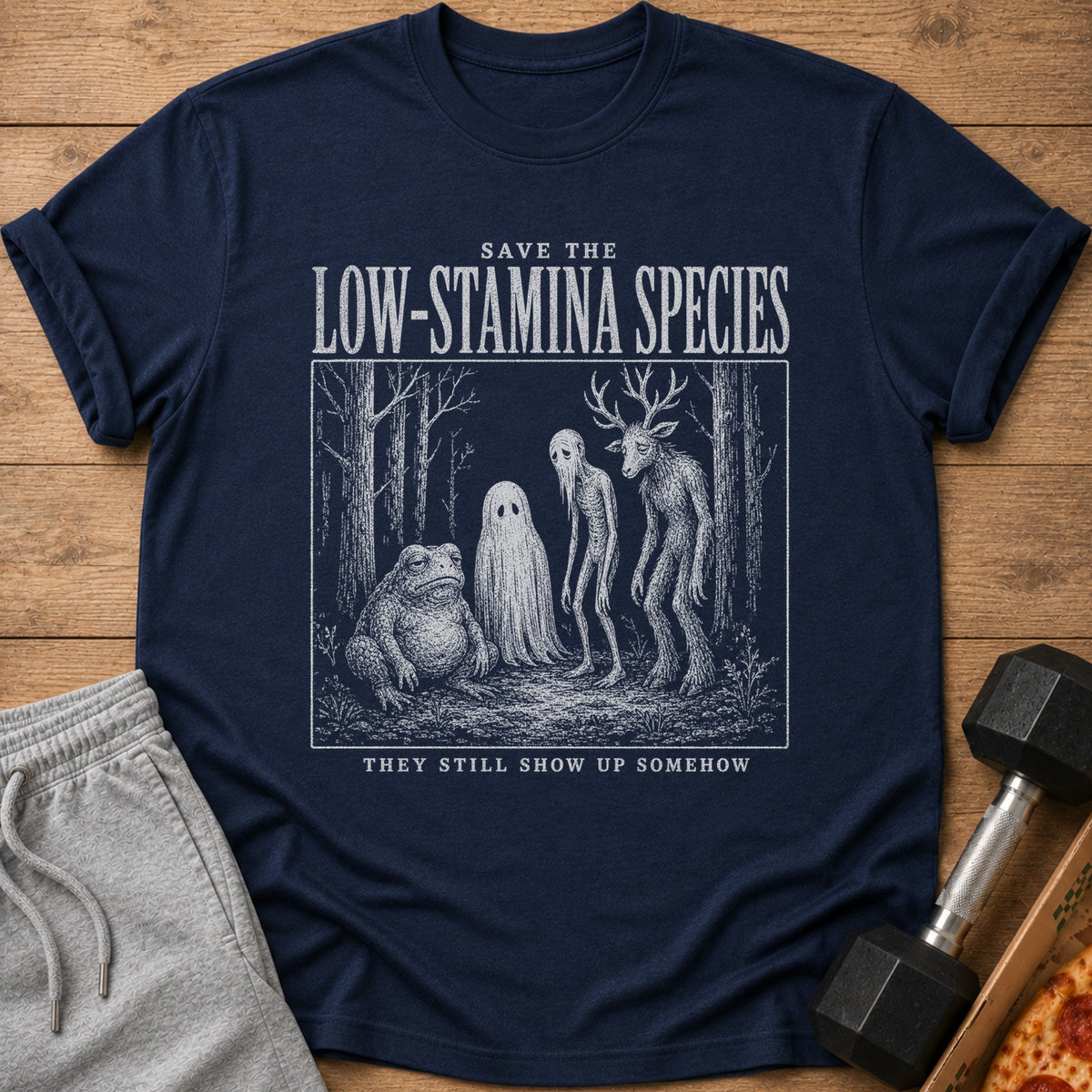 Dark blue t-shirt with text and illustration of mythical creatures in a forest.