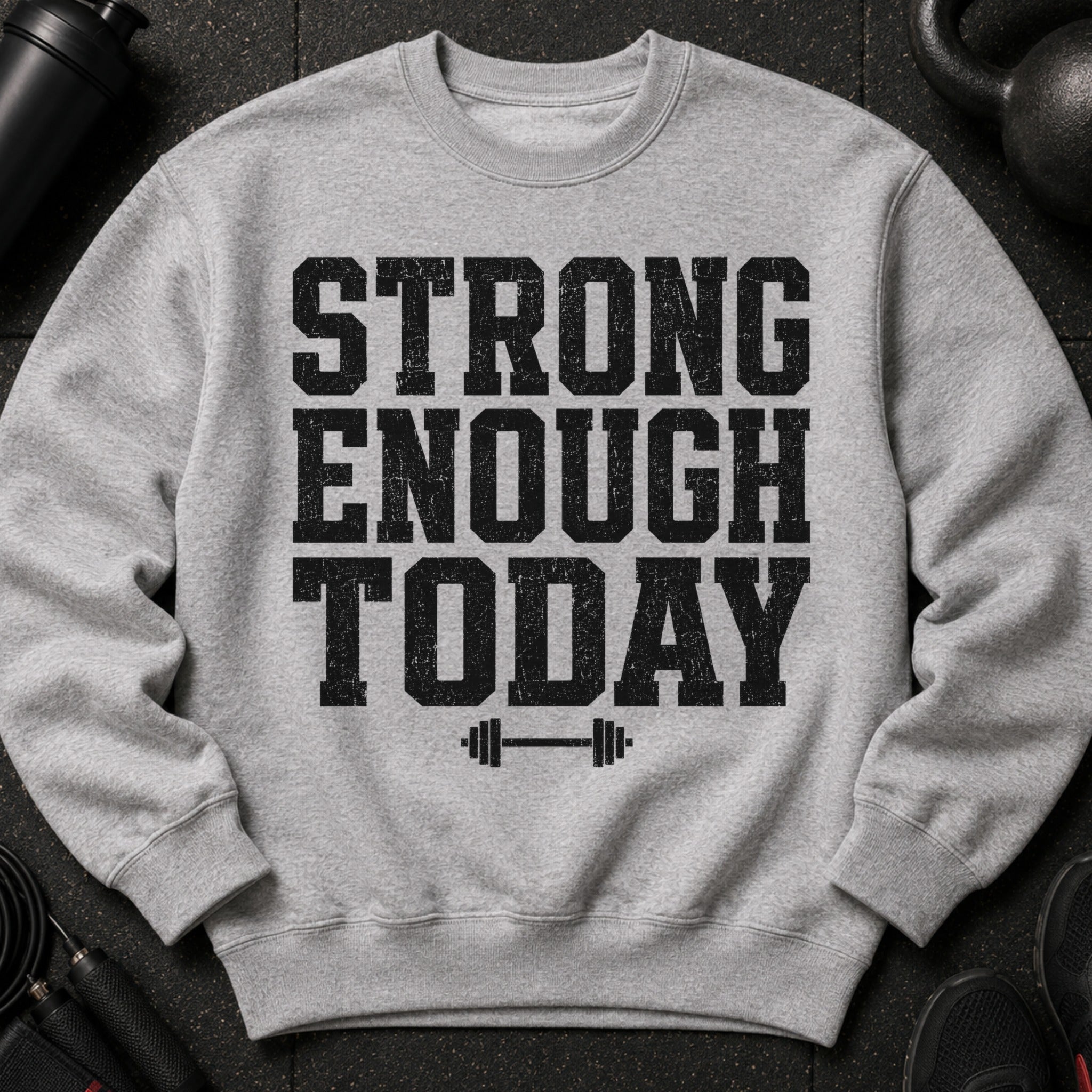 Grey sweatshirt with black distressed text "STRONG ENOUGH TODAY" and barbell graphic.