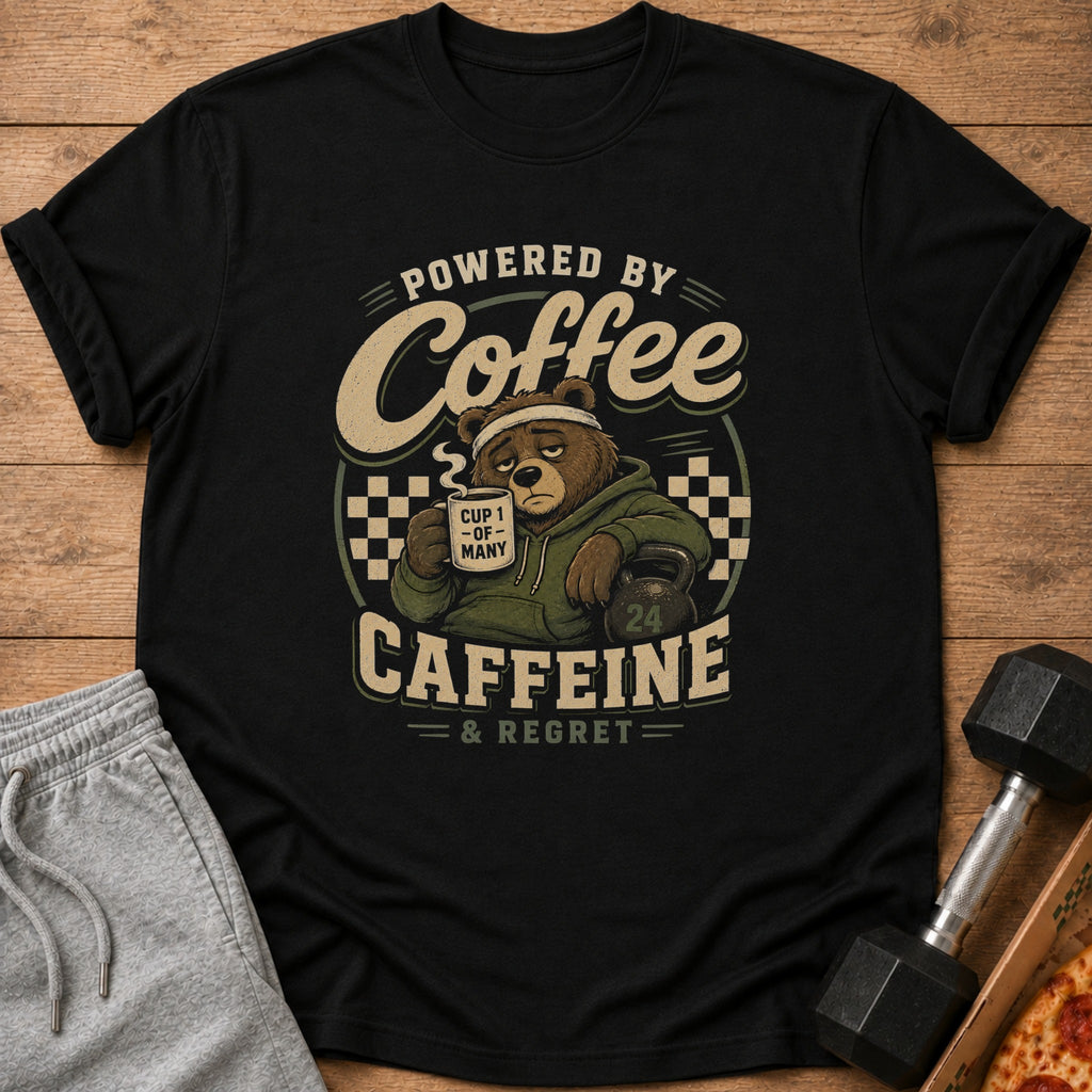 T-shirt with a bear holding coffee and a kettlebell, reading "Powered by Coffee & Regret".