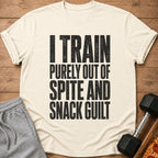 Cream t-shirt with black text: "I TRAIN PURELY OUT OF SPITE AND SNACK GUILT".