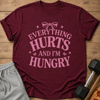 Maroon t-shirt with pink text "Everything Hurts And I'm Hungry".