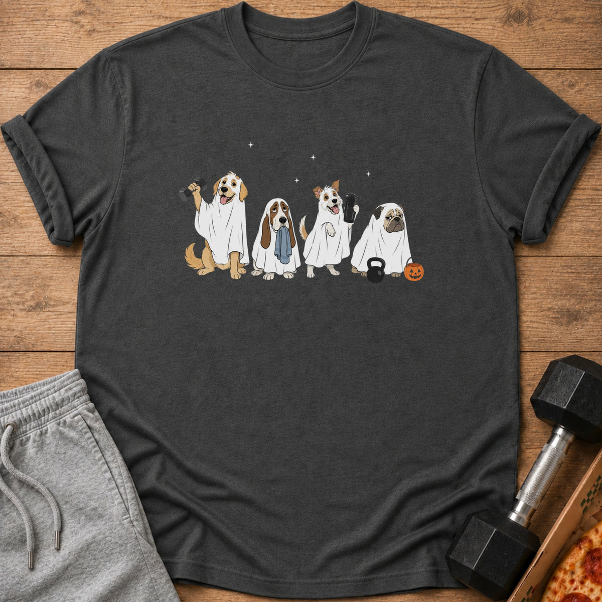 Four dogs in ghost costumes with weights and a pumpkin are printed on a dark t-shirt.