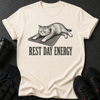 Cream t-shirt with a graphic of a cat and text "REST DAY ENERGY".