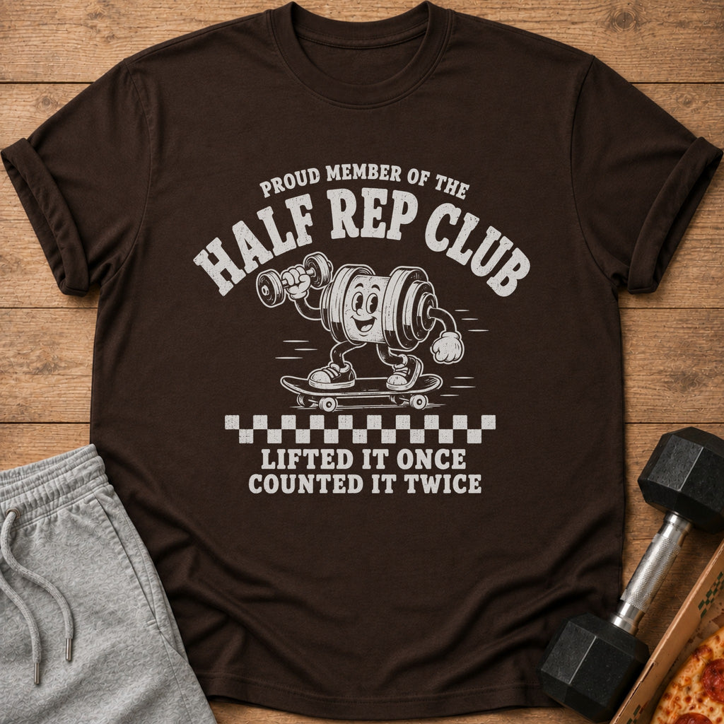 Brown t-shirt with "Proud Member of the Half Rep Club" text and cartoon weight on skateboard.