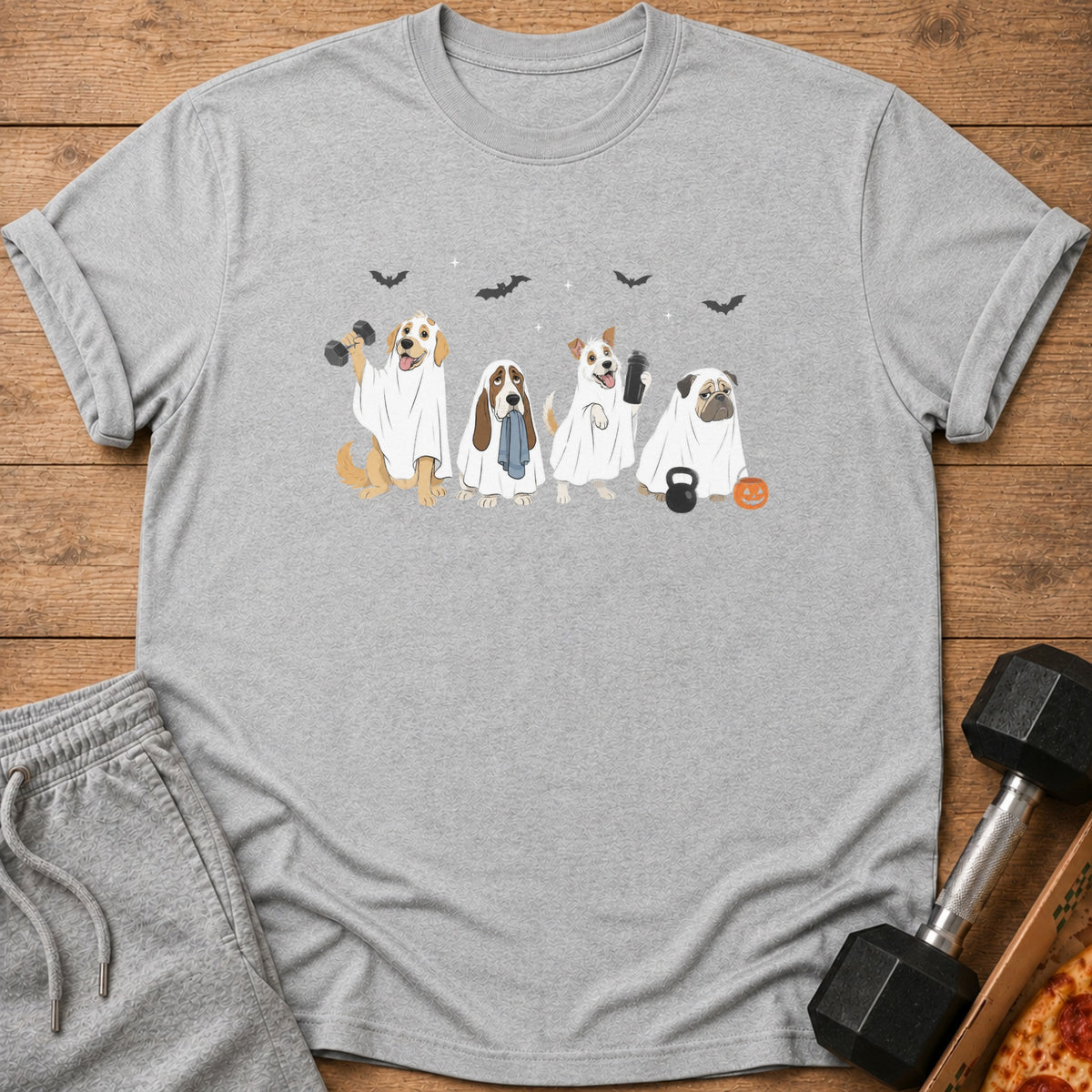 Four dogs in ghost costumes with Halloween decorations and dumbbells.