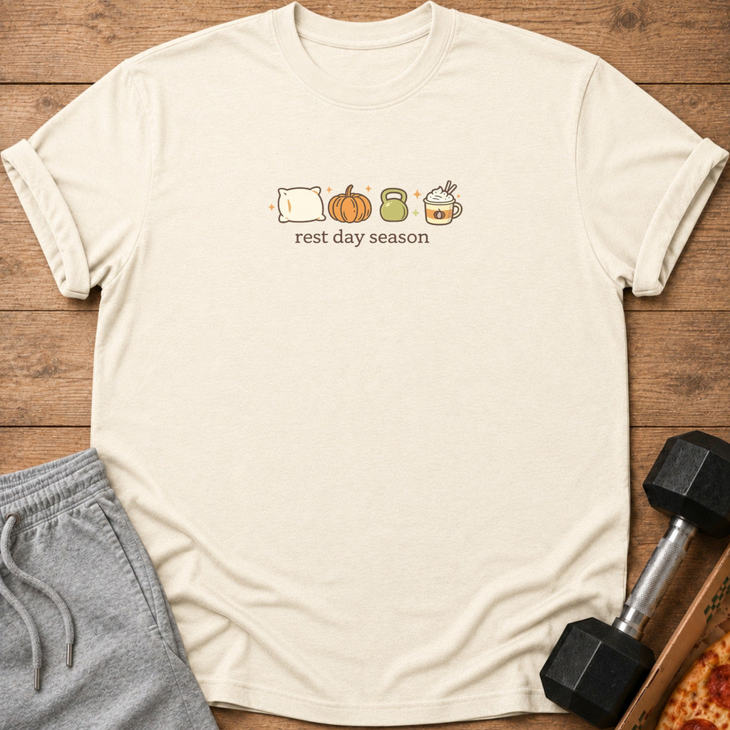 Cream t-shirt with pillow, pumpkin, kettlebell, and coffee icons and "rest day season" text.