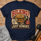 T-shirt with cartoon burger lifting dumbbell, text "BULKING? JUST HUNGRY."