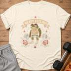 T-shirt graphic: anthropomorphic frog lifting a barbell with "Heavy Feelings" text.