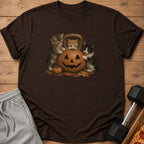 Three kittens play around a jack-o'-lantern and kettlebell on a t-shirt.