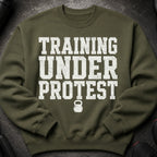 Olive green sweatshirt with "TRAINING UNDER PROTEST" and a kettlebell graphic.