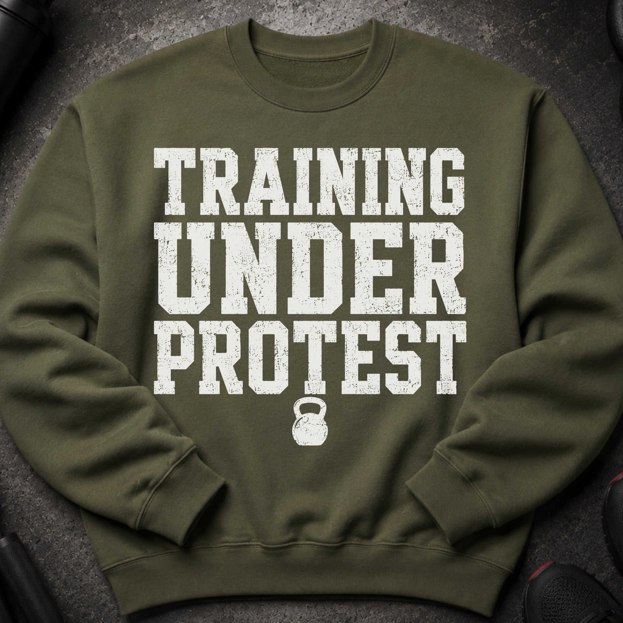 Olive green sweatshirt with "TRAINING UNDER PROTEST" and a kettlebell graphic.