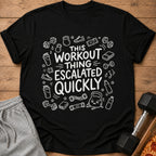 Black t-shirt with white text "This Workout Thing Escalated Quickly" and fitness icons.