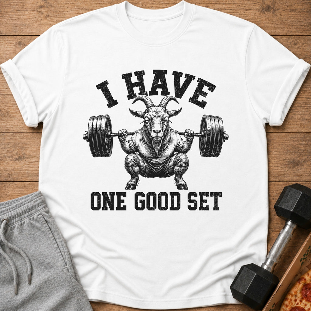 White t-shirt with graphic of a goat lifting weights and text "I HAVE ONE GOOD SET."