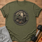 Olive green t-shirt with a graphic of a weightlifter in a gym.