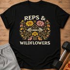 Black t-shirt with "REPS & WILDFLOWERS" text and a barbell surrounded by flowers.