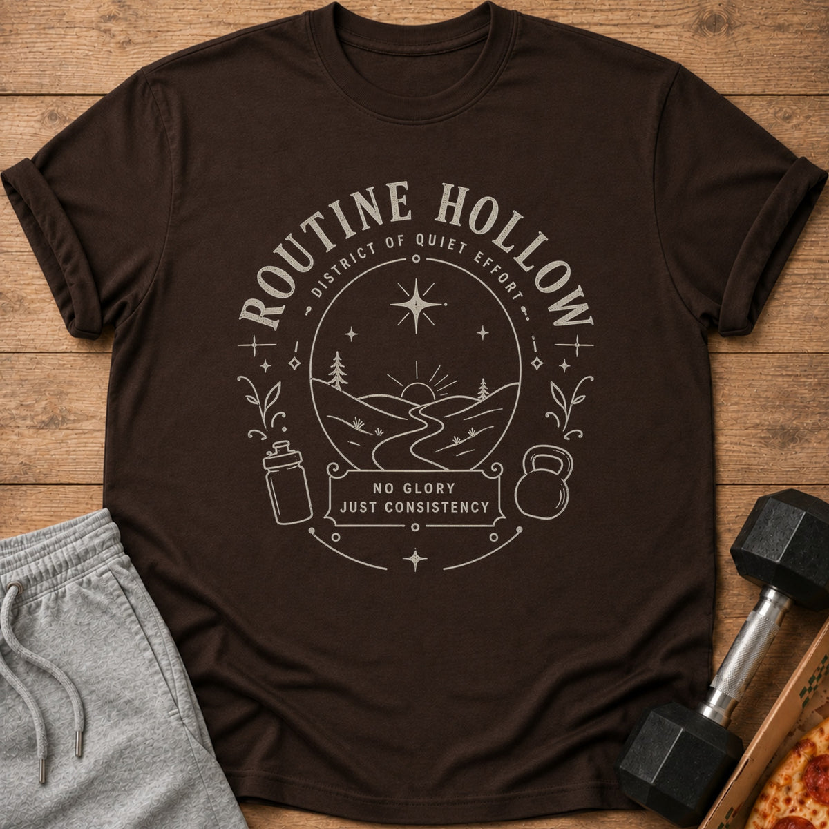 Brown t-shirt with "Routine Hollow" design and workout motifs.