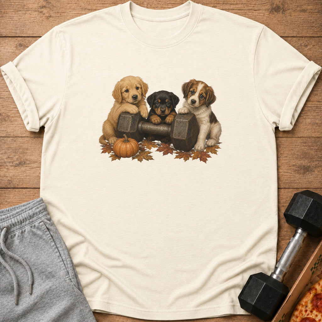 Three puppies lean on a dumbbell with autumn leaves and a pumpkin.