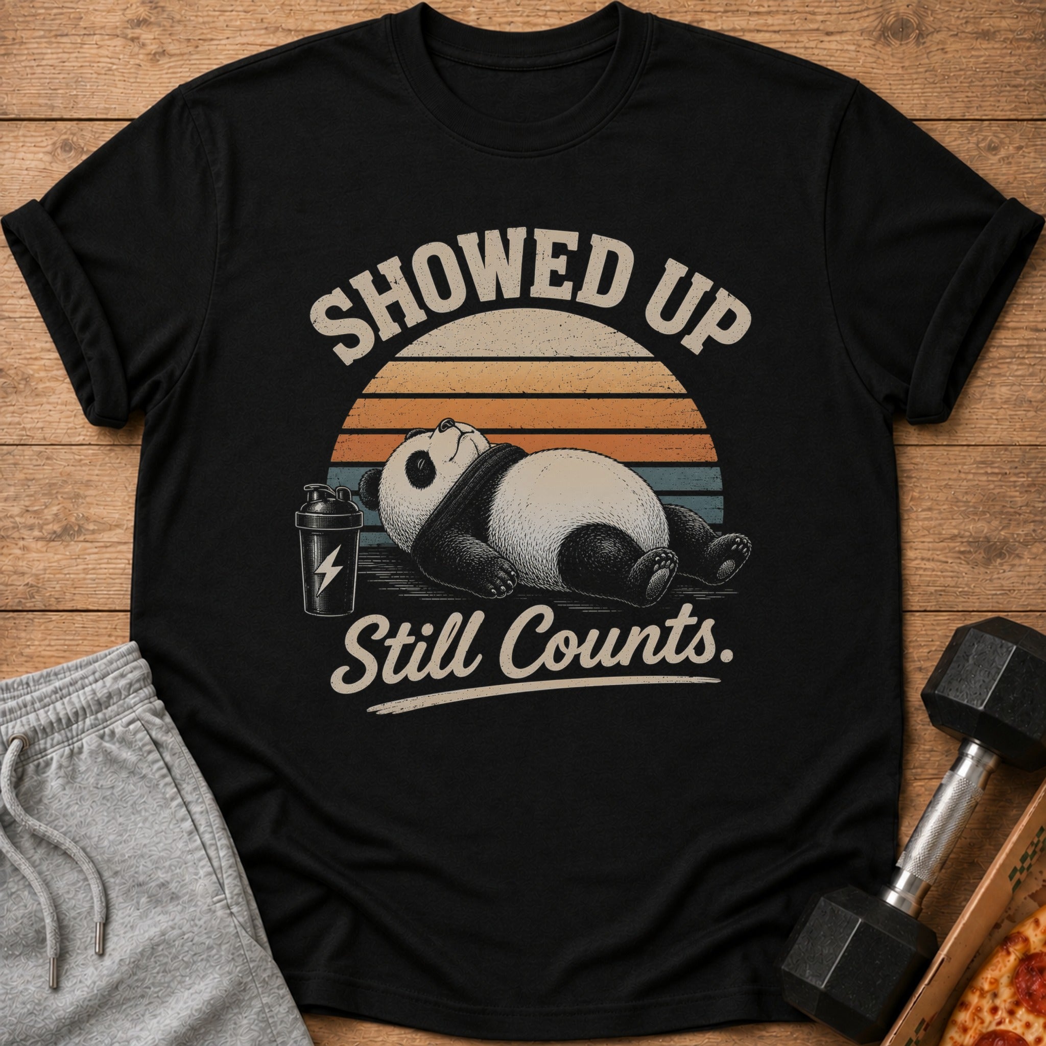 Black t-shirt with a panda and text "Showed Up Still Counts."