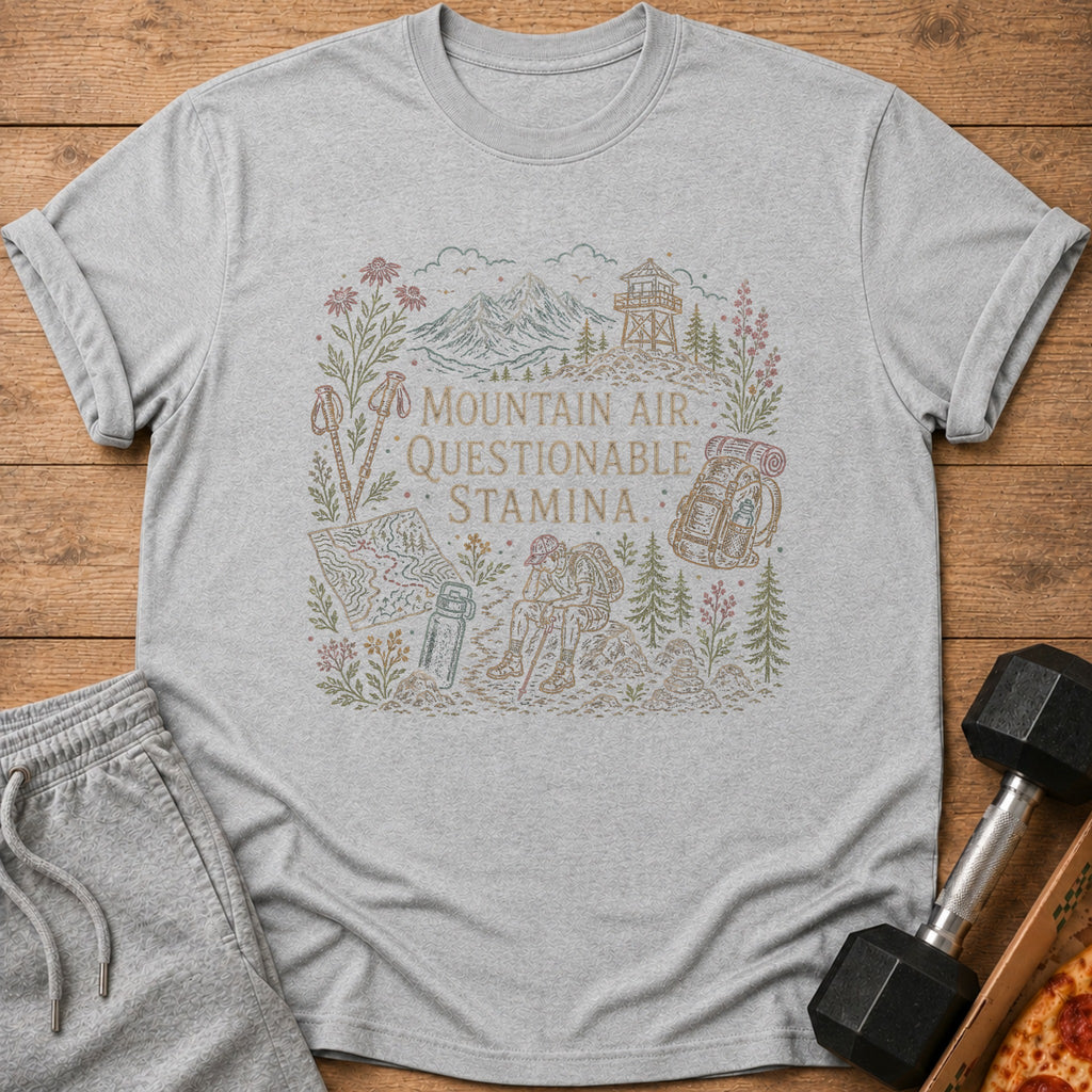 Light grey t-shirt with a line drawing of mountains, trees, and a hiker.
