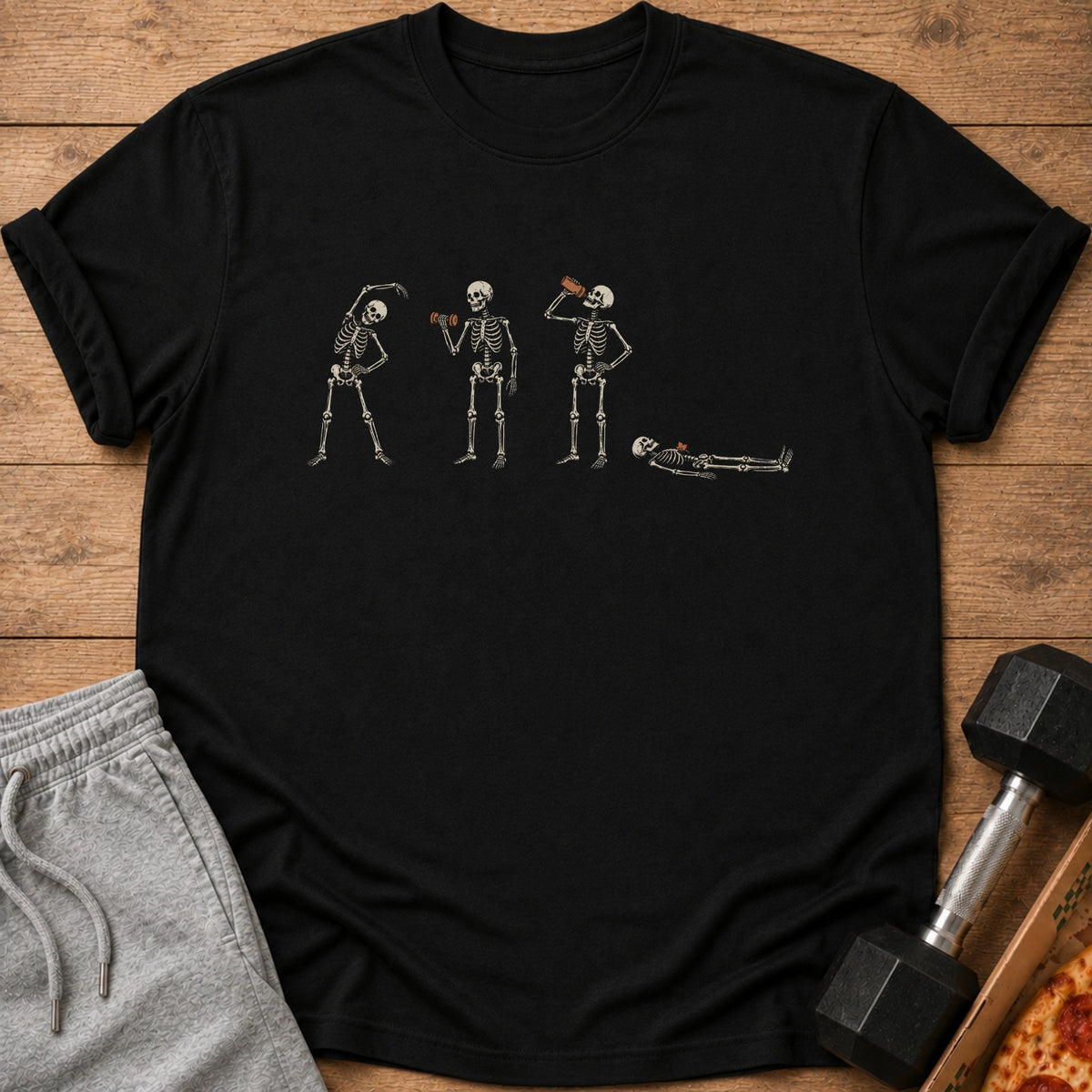 Black t-shirt with skeleton graphic showing exercise, drinking, and resting.