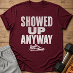 Maroon t-shirt with "SHOWED UP ANYWAY" text and a running shoe graphic.