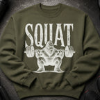 Green sweatshirt with "SQUAT" text and a hairy creature lifting weights.