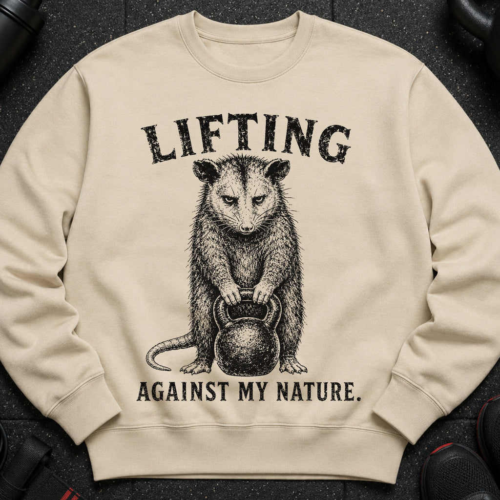 Opossum lifting a kettlebell, text: "LIFTING AGAINST MY NATURE."